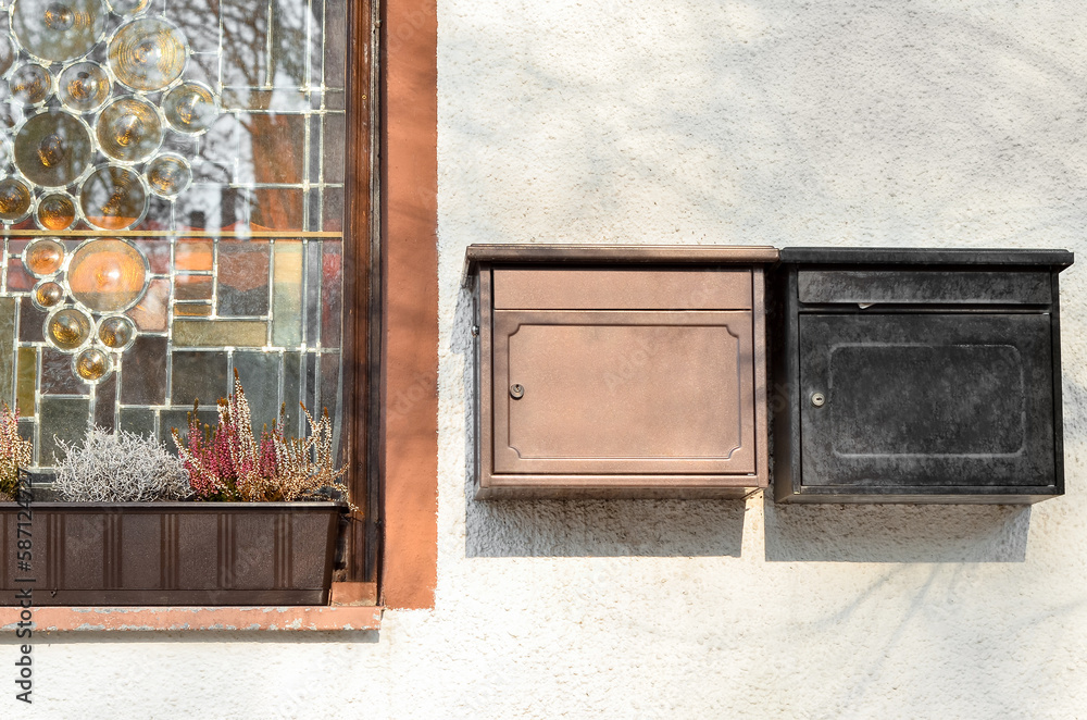 View of mailboxes on white building wall