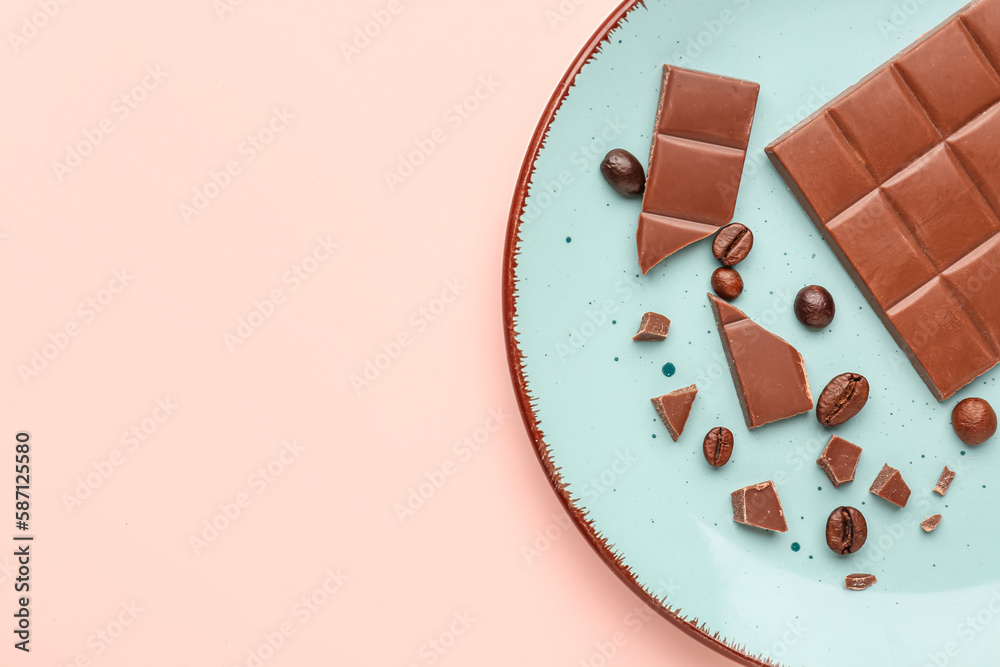 Plate with pieces of tasty chocolate and coffee beans on color background, closeup