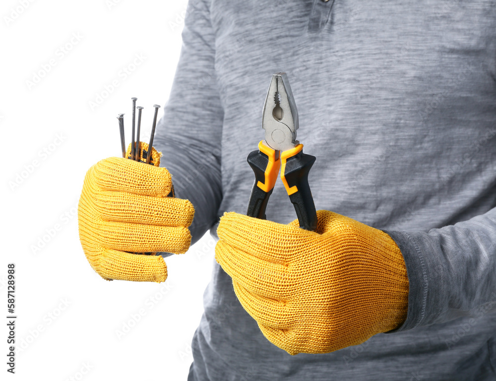 Man in gloves holding pliers and nails on white background