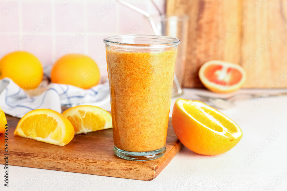 Glass of healthy orange smoothie on table