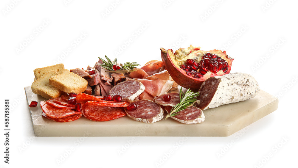 Board with assortment of tasty deli meats isolated on white background