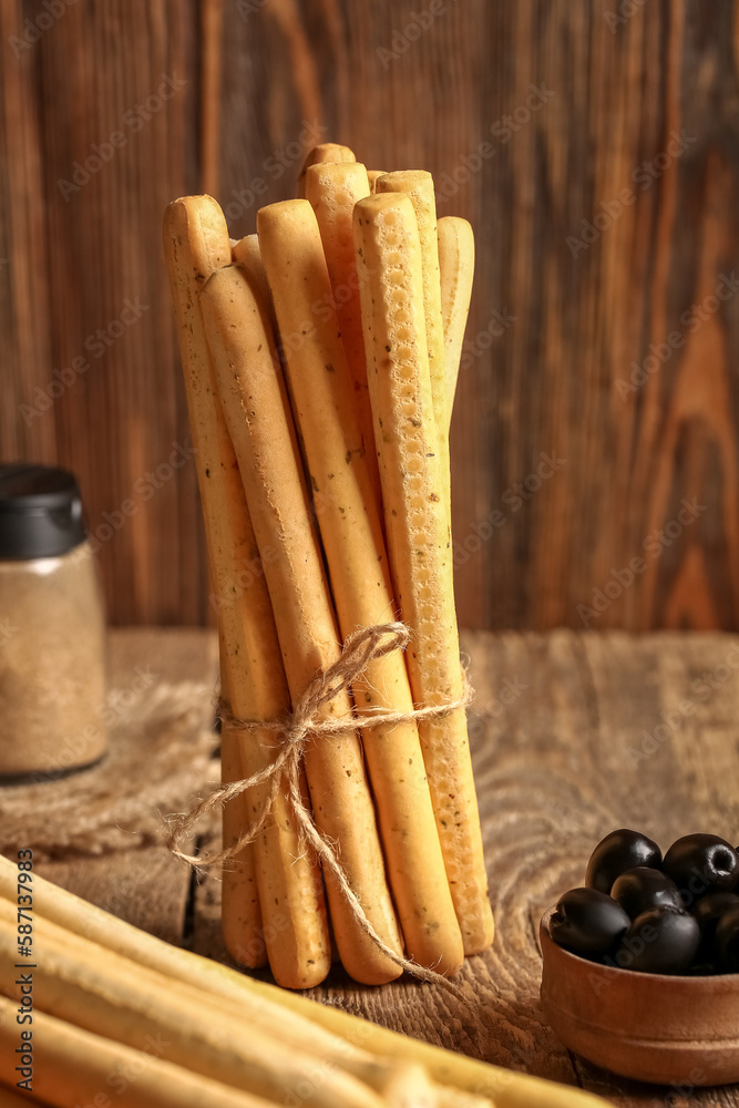 Bunch of tasty Italian Grissini on wooden background