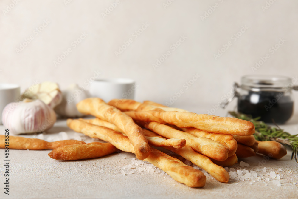 Tasty Italian Grissini on light background