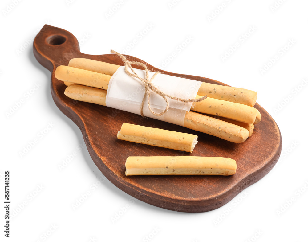 Wooden board with bunch of tasty Italian Grissini on white background