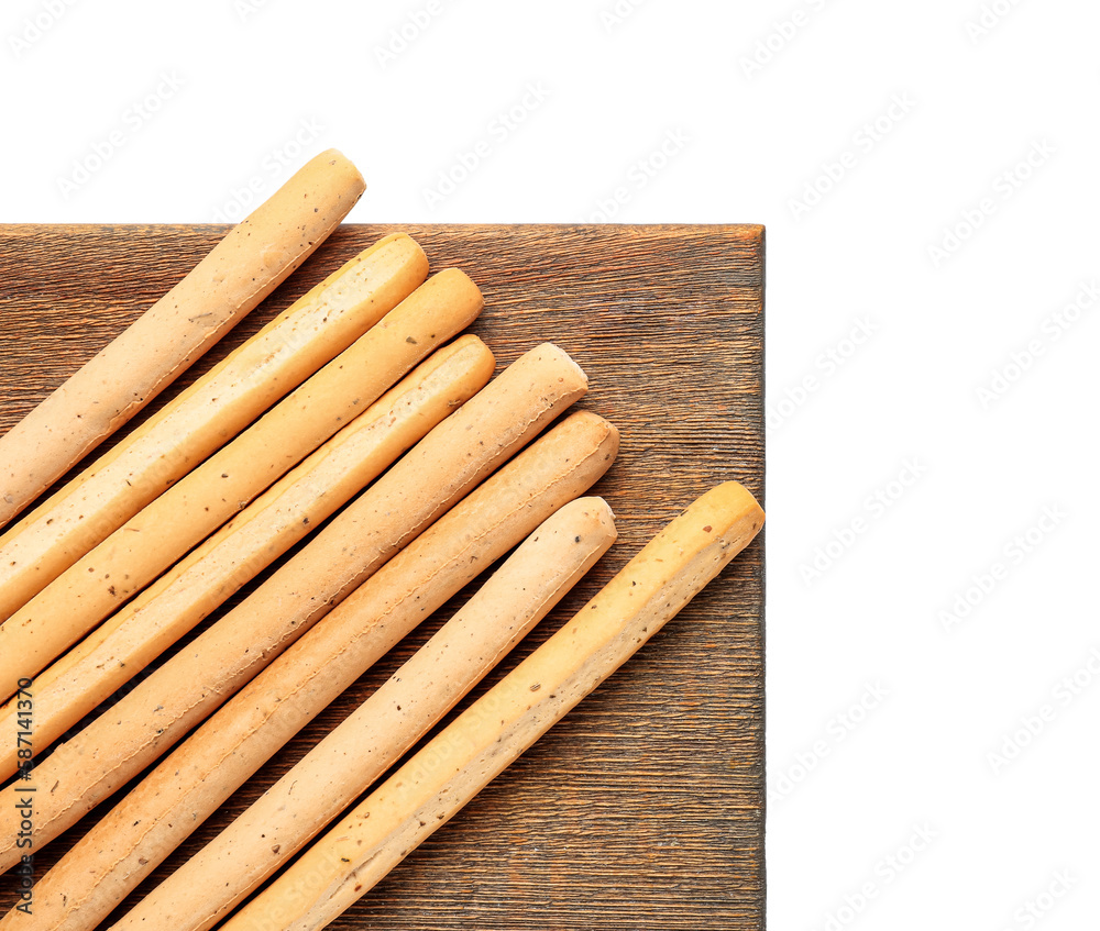 Wooden board with tasty Italian Grissini on white background, closeup