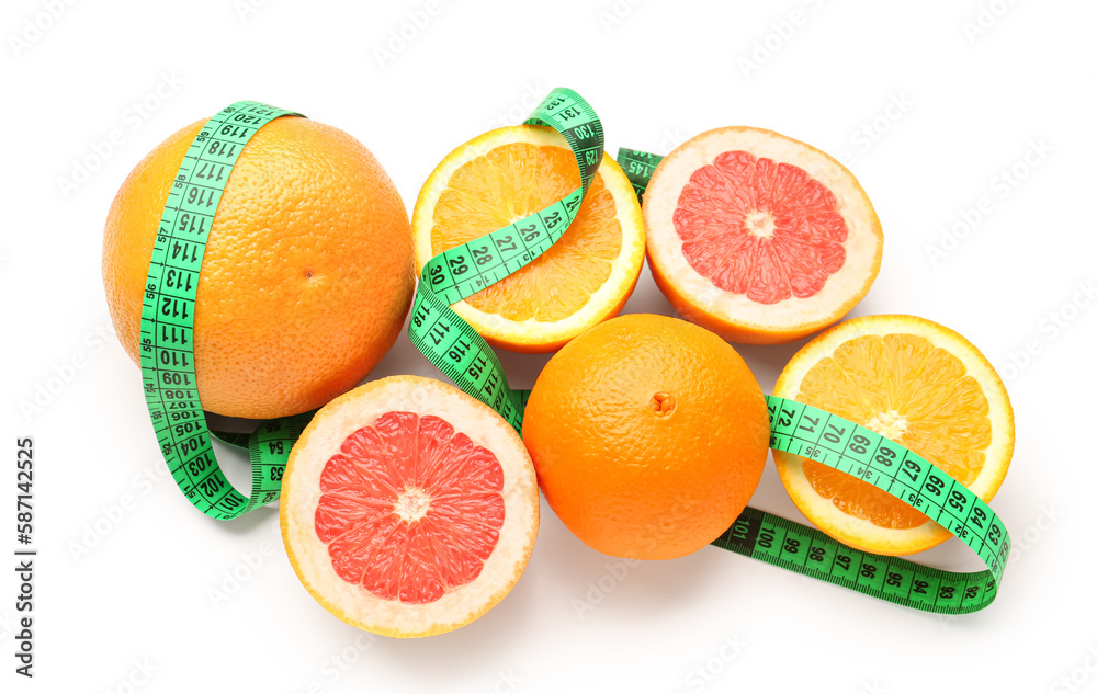 Cut oranges and green measuring tape on white background. Diet concept