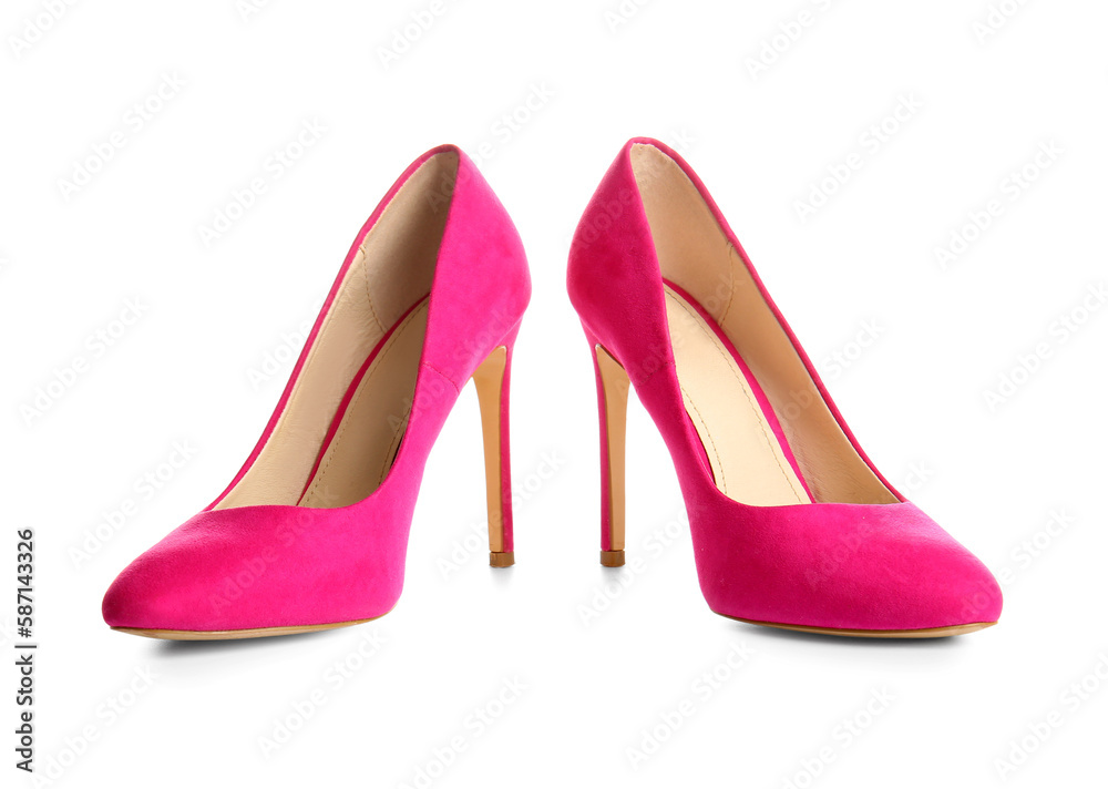 Pair of pink high heeled shoes on white background