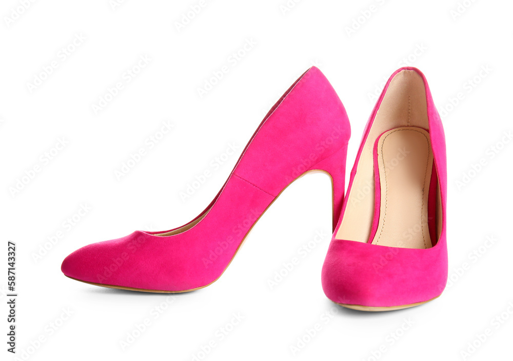 Pair of pink high heeled shoes on white background