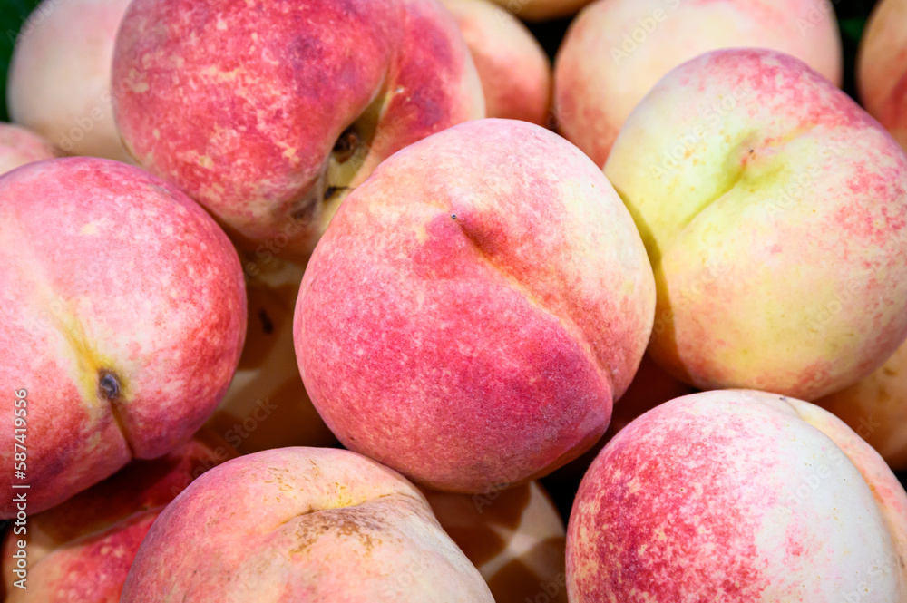 close up fresh ripe pink peaches for sale