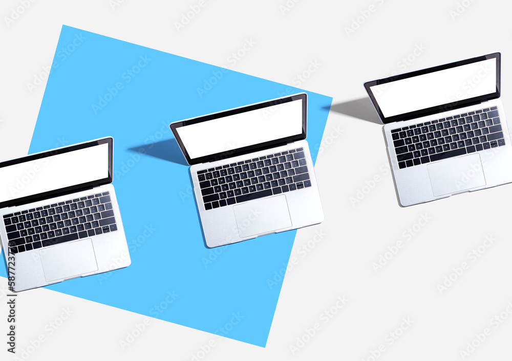 Three laptop computers with shadow - Flat lay