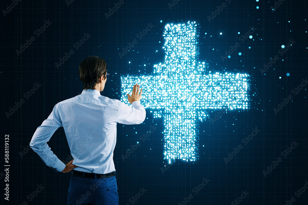 Back view of businessman pointing and using creative glowing medical cross plus hologram on dark bac