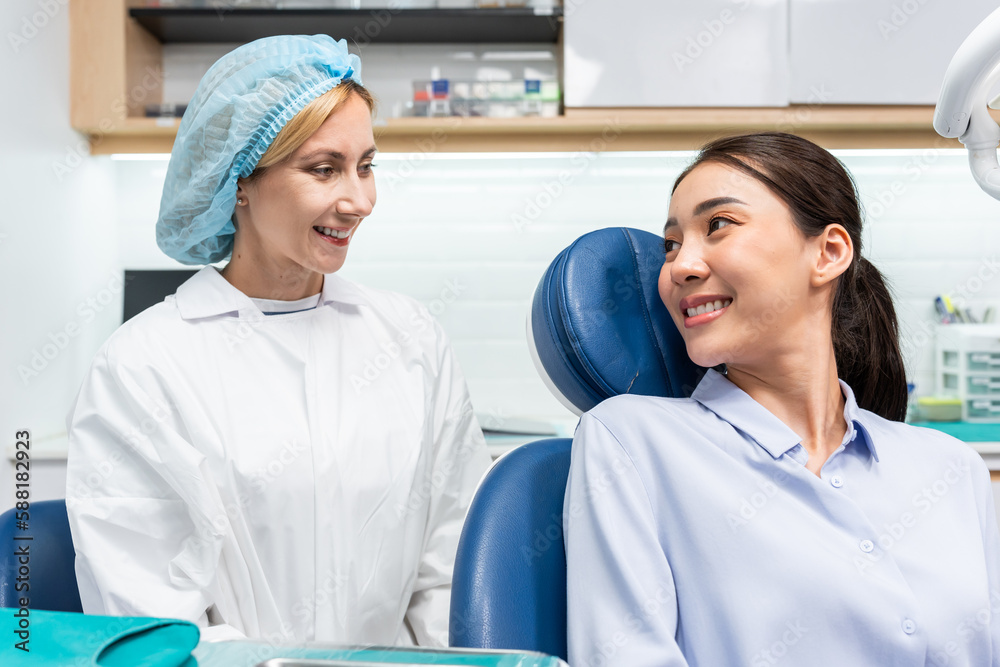 Caucasian dentist examine tooth for young girl at dental health clinic. 