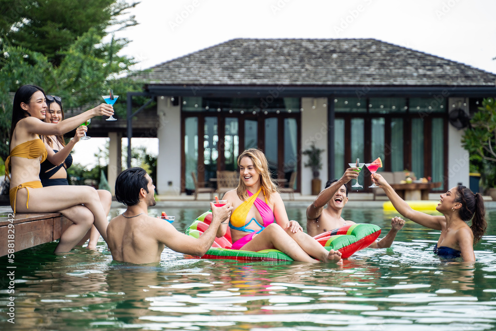 Group of diverse friend drinking alcohol, having a pool party together. 