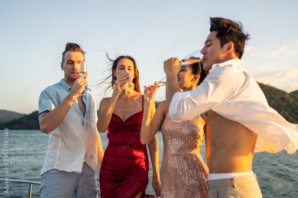 Group of diverse friends drink champagne while having a party in yacht. 