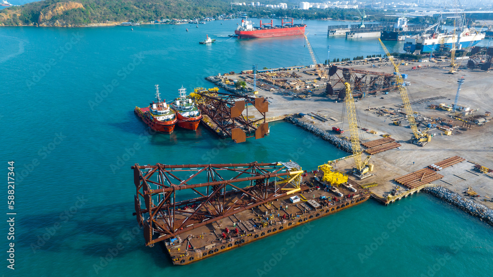 Big Drilling rid on Smart Barge. Construction port at harbor cranes at sunset. Shipyard at sunset. M