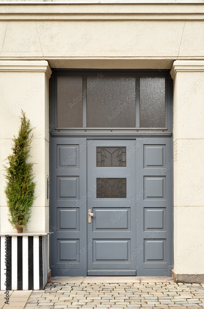 View of city building with grey wooden door