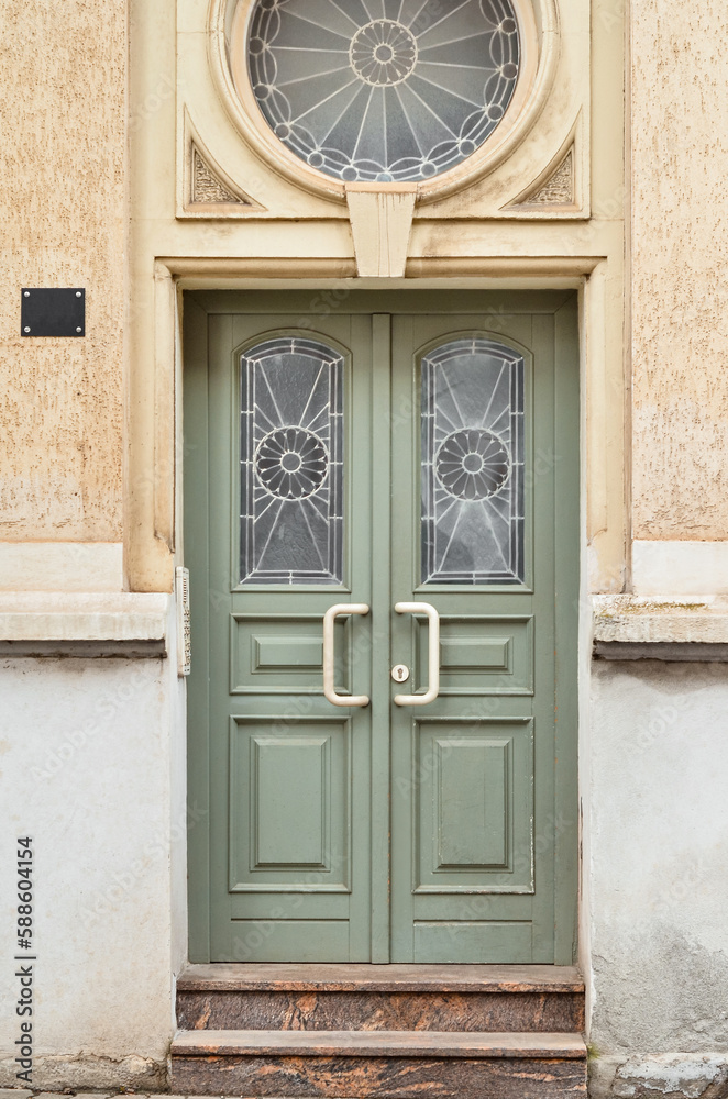 View of old building with green wooden door