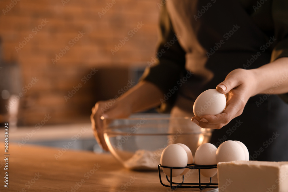 Woman making dough for pasta at table in kitchen, closeup