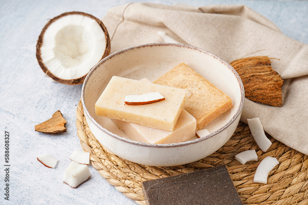 Plate with natural soap bars and coconut on light table