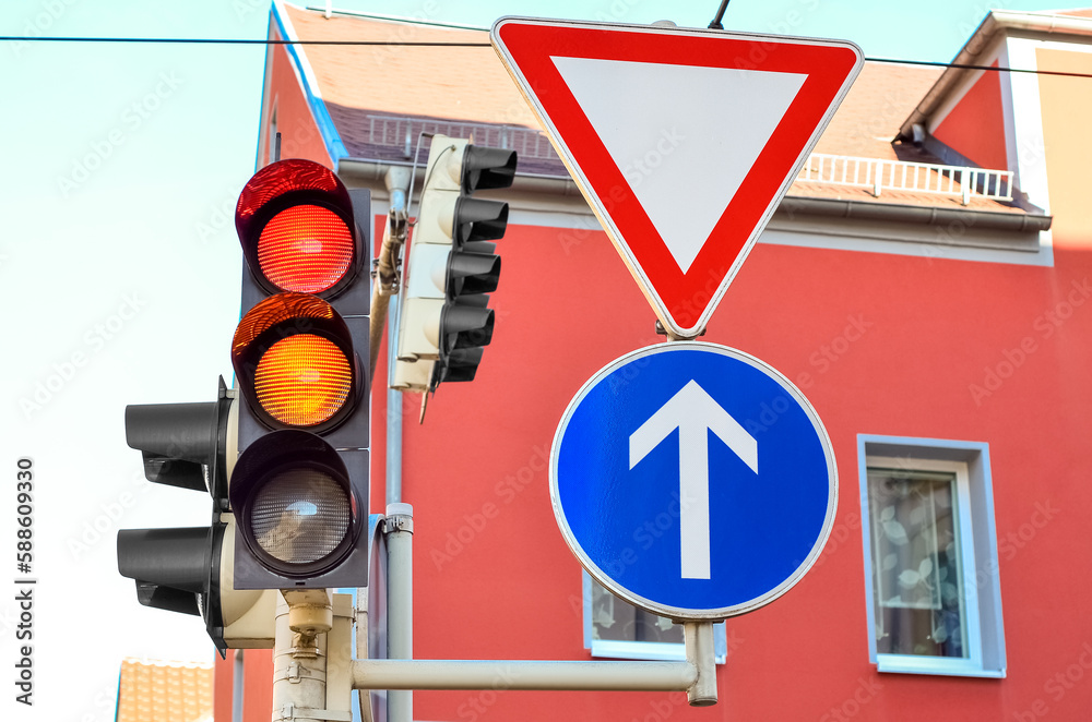 View of traffic lights with road signs in city, closeup