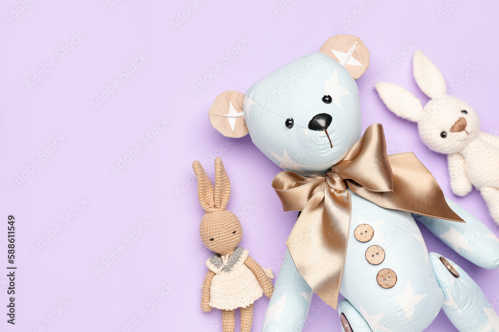 Toy bear with bunnies on lilac background