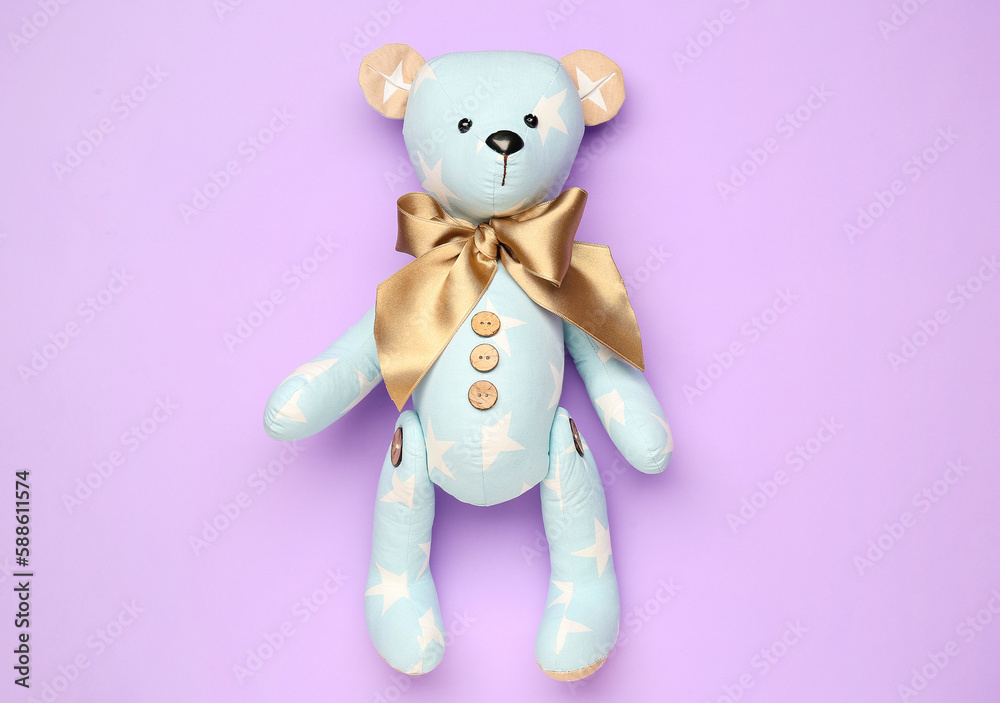 Toy bear on lilac background