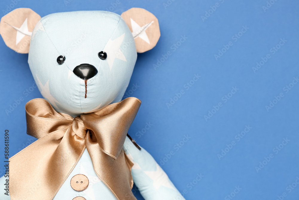 Toy bear on blue background, closeup