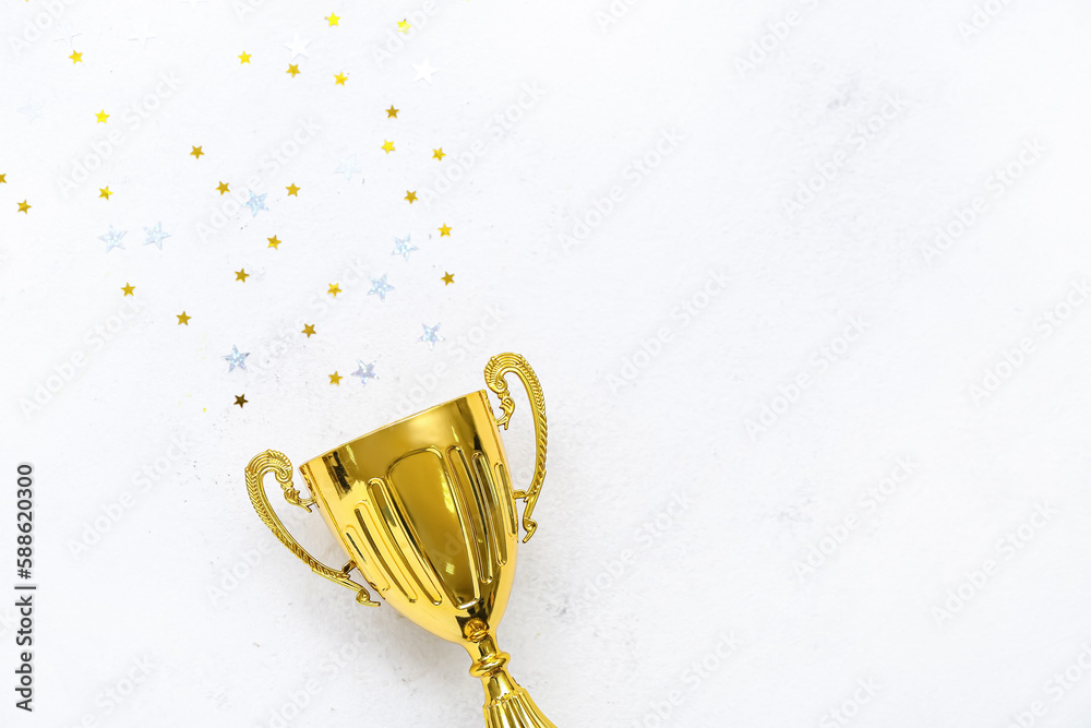 Gold cup with stars on white background