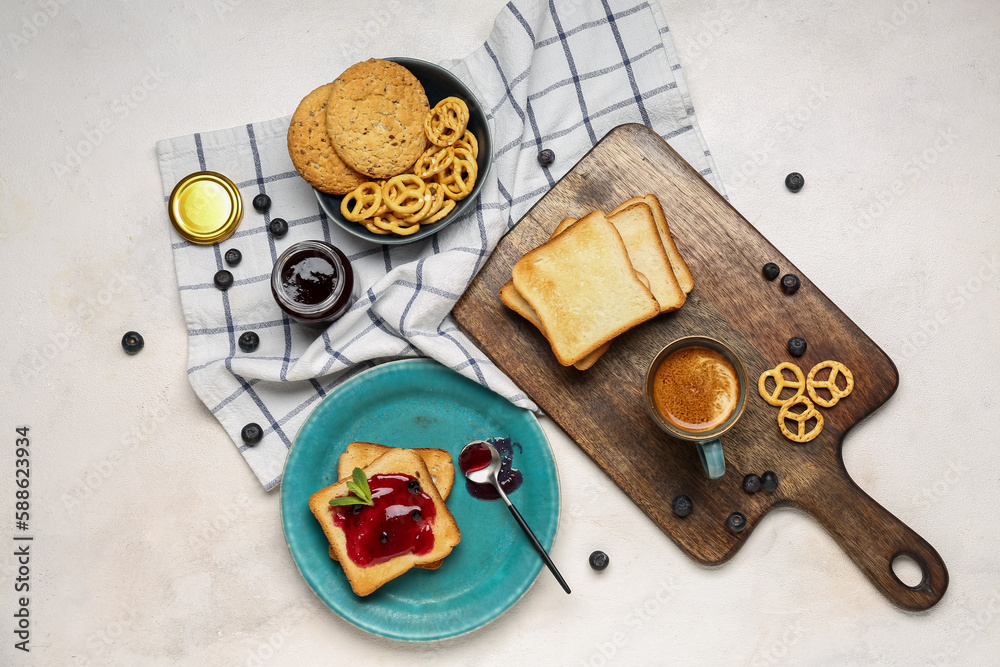 Tasty toasts with blueberry jam, cookies and cup of coffee on light background