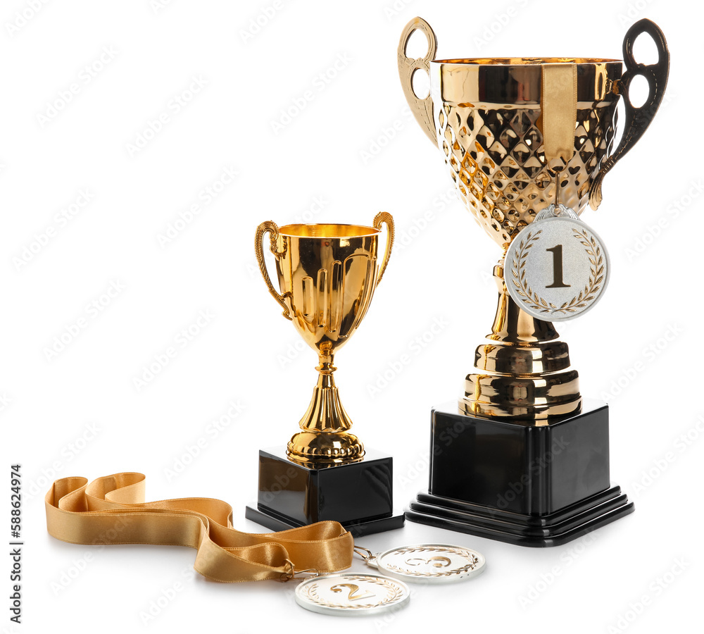 Gold cups with prize medals on white background