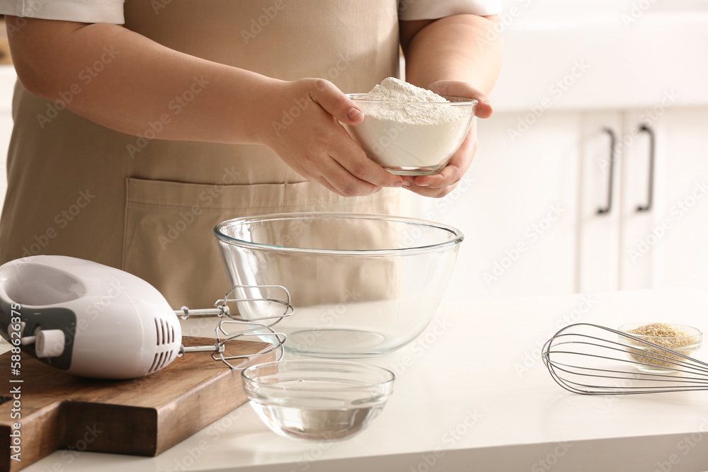 Woman preparing dough for Italian Grissini at table in kitchen, closeup