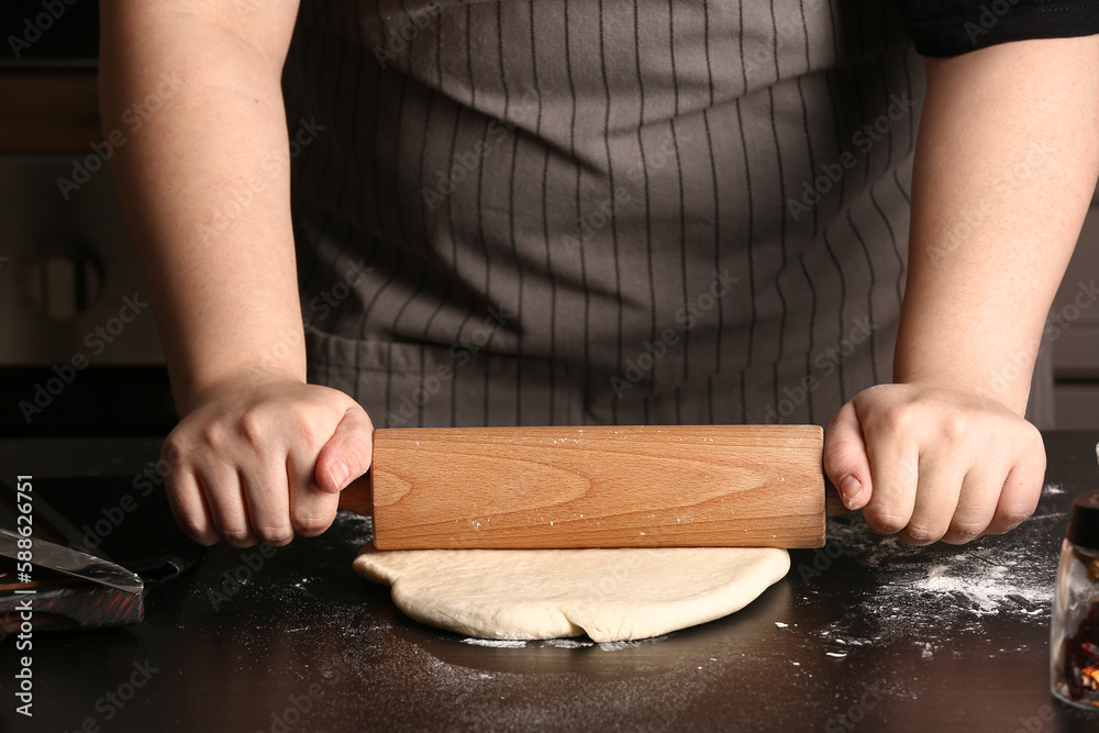 Woman preparing dough for Italian Grissini at table in kitchen, closeup