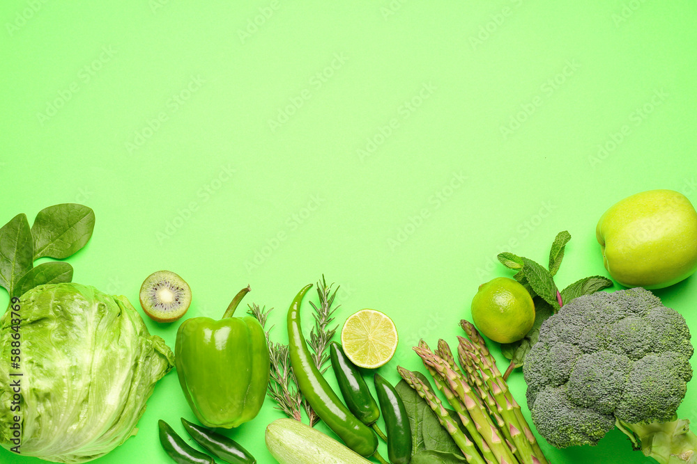 Composition with different fresh vegetables and fruits on green background