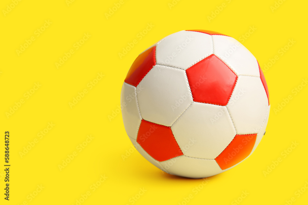 Soccer ball on yellow background