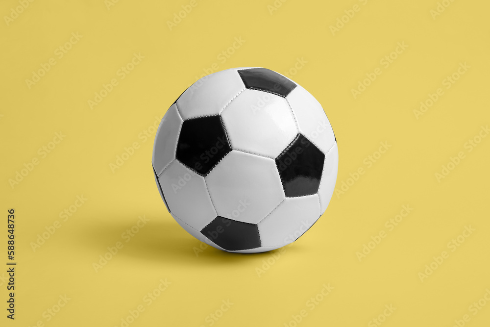 Soccer ball on beige background