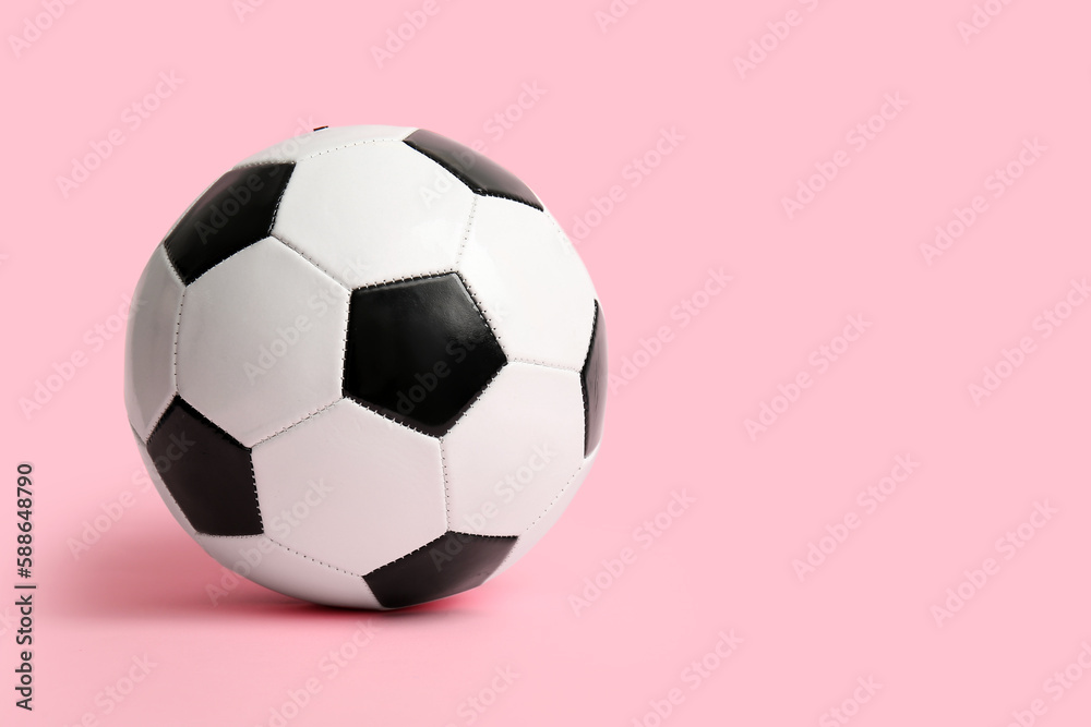 Soccer ball on pink background