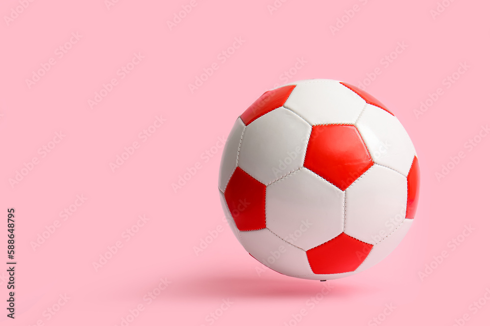 Soccer ball on pink background