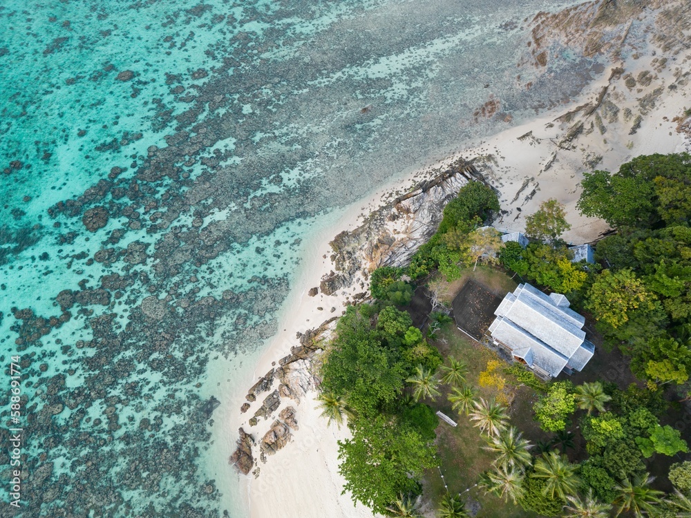 Aerial of the Sunset Beach with green trees on Ko Lipe island in Thailand surrounded by the blue sea