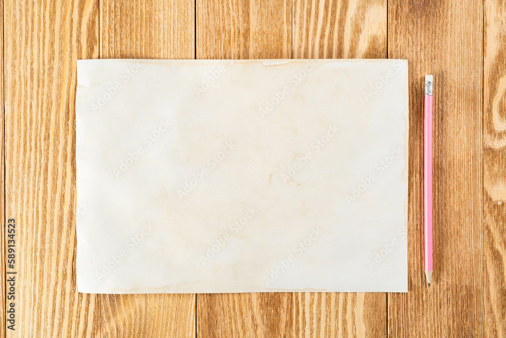 Sheet of paper lying on wooden table