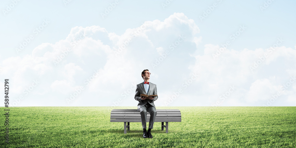 Young businessman or student studying the science in summer park