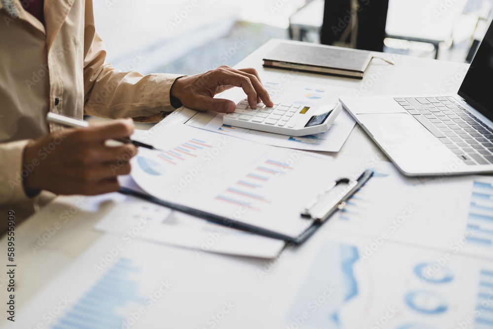 Businessman pointing at financial chart document and statistical market growth analysis. Accounting 