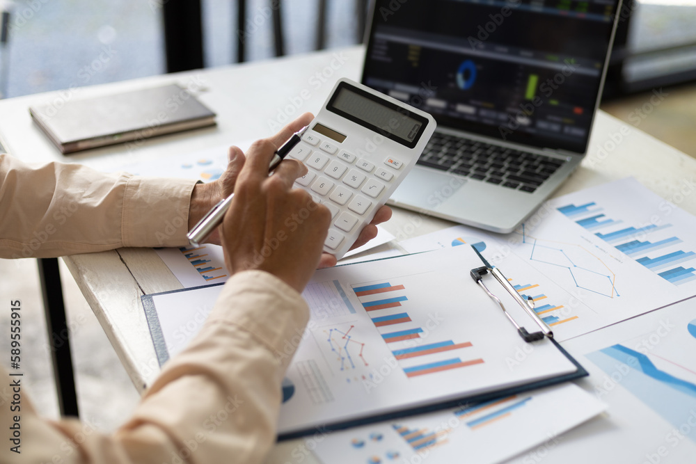 Businessman pointing at financial chart document and statistical market growth analysis. Accounting 