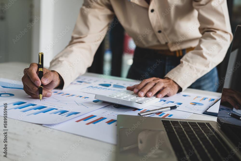 Businessman pointing at financial chart document and statistical market growth analysis. Accounting 