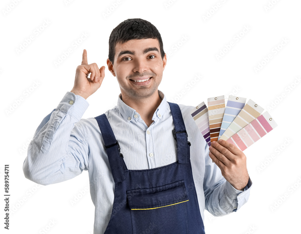 Male painter with color palettes pointing at something on white background