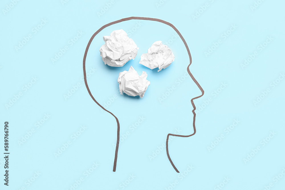 Drawn human head with crumpled paper on blue background. Insight concept