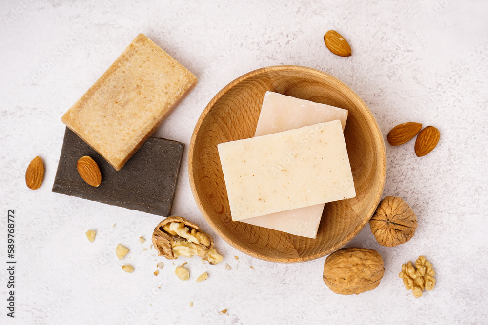 Composition with natural soap and nuts on light background