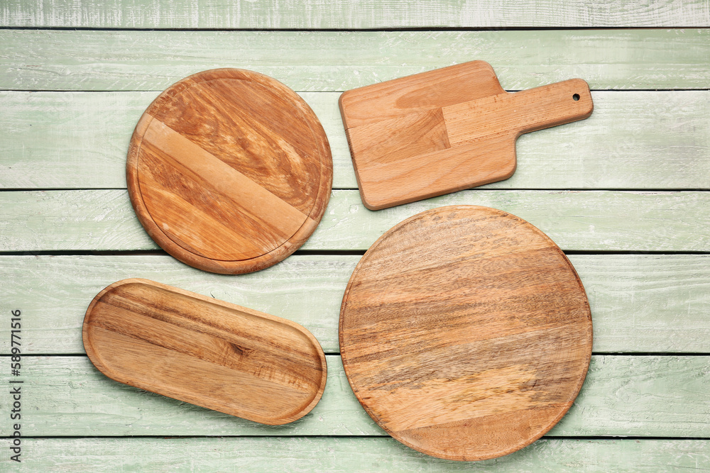 Set of kitchen boards on color wooden background