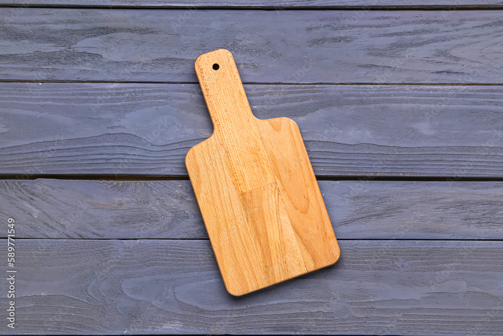 Kitchen board on color wooden background