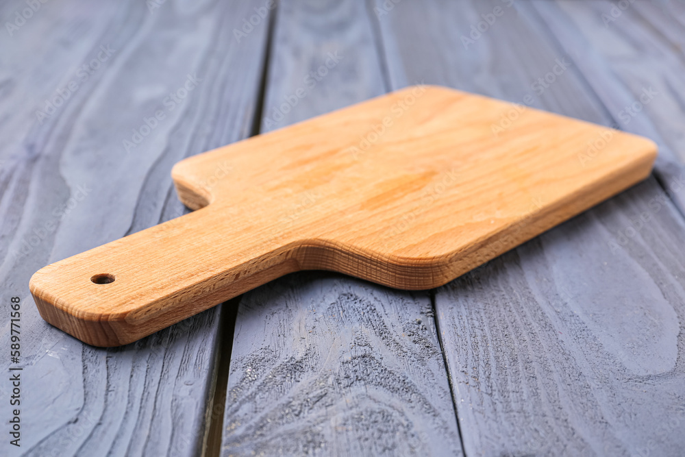 Kitchen board on color wooden background