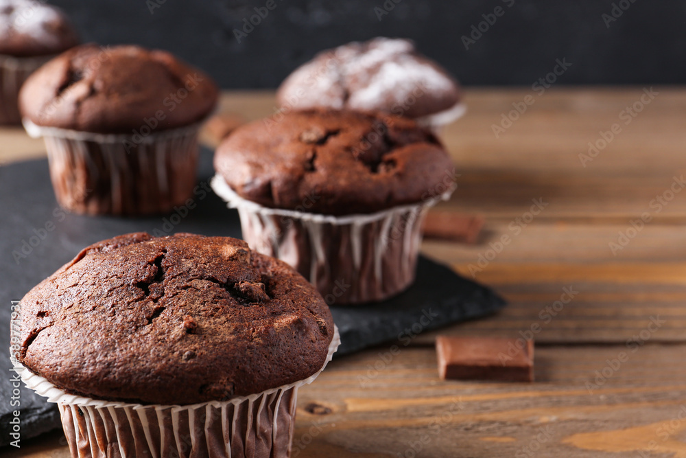 Tasty chocolate cupcakes on wooden table